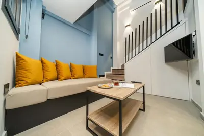 a living room with a couch and a table at New luxury studio in the historic center in Limassol
