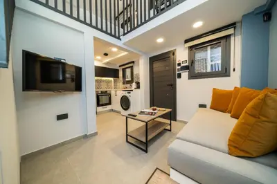 a living room with a couch and a table at New luxury studio in the historic center in Limassol