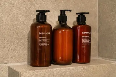 a group of three shampoo bottles sitting on a counter at New luxury studio in the historic center in Limassol