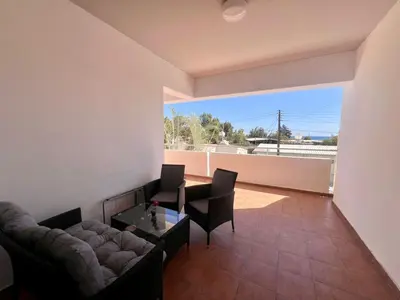 a living room with a couch and a table at 2 Bed 1st Floor Apartment Mc Kenzie -3 min walk to the beach! in Larnaka