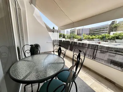 a balcony with a table and chairs and a window at STAY Sunsea Studio in Limassol