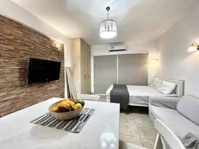 a hotel room with a bowl of fruit on a table at STAY Sunsea Studio in Limassol