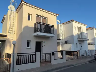 a white building with a balcony on the side of a street at Pernera Sunrise Villa in Paralimni