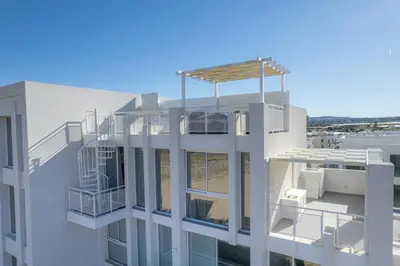 an aerial view of a building with a balcony at Blue Horizon Seaview Suite with Rooftop and Pool in Paralimni in Paralimni