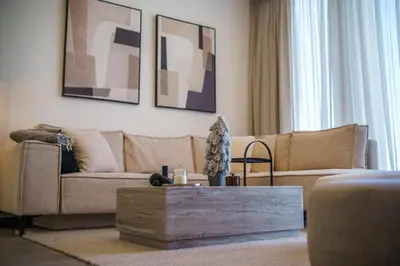 a living room with a couch and a coffee table at Blue Horizon Seaview Suite with Rooftop and Pool in Paralimni in Paralimni