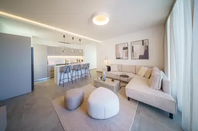 a living room with a couch and a table at Blue Horizon Seaview Suite with Rooftop and Pool in Paralimni in Paralimni