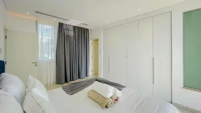 a bedroom with a white bed with two pillows at Villa Cielo Mare in Ayia Napa