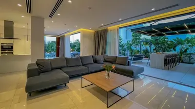 a living room with a couch and a table at Villa Cielo Mare in Ayia Napa