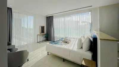 a bedroom with a bed and a large window at Villa Cielo Mare in Ayia Napa