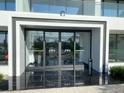 a large glass door of a building at Grand Sapphire Iskele Apartment С 161 in Larnaka