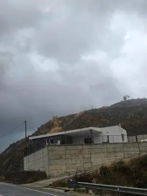 a building on the side of a hill at Selladi Mountain Escape in Ephtagonia