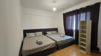 a bedroom with a bed with a black and white comforter at Sea View Apartment Finikoudes in Larnaka