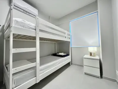 a bedroom with two bunk beds and a window at STAY Atalanta Apartment in Larnaka