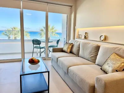a living room with a couch and a glass table at STAY Atalanta Apartment in Larnaka