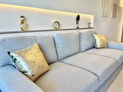 a blue couch with pillows in a living room at STAY Atalanta Apartment in Larnaka