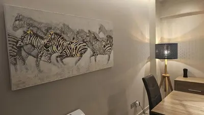 a painting of a herd of zebras on a wall at STAY Executive Retreat in Nicosia