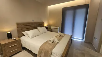 a bedroom with a large bed with towels on it at STAY Executive Retreat in Nicosia