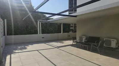 a patio with two chairs and a desk with a computer at STAY Executive Retreat in Nicosia