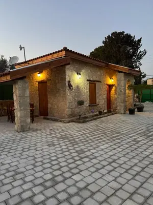 a stone house with a patio in front of it at Stone house in Pallouriotissa