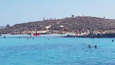 a group of people in the water at a beach at Summer Breeze apt by Nissi Beach in Ayia Napa