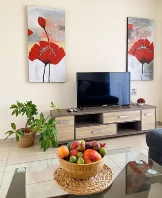 a living room with a bowl of fruit on a table at Summer Breeze apt by Nissi Beach in Ayia Napa