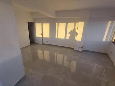 a shadow of a person standing in an empty room at Limassol City Center in Limassol