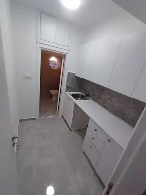 a white kitchen with a sink and a toilet at Limassol City Center in Limassol