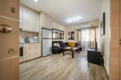 a living room with a couch and a table at Seafront 1 bedroom flat in Limassol