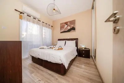 a bedroom with a bed with two teddy bears on it at Seafront 1 bedroom flat in Limassol