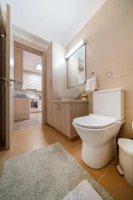 a bathroom with a toilet and a sink at Seafront 1 bedroom flat in Limassol