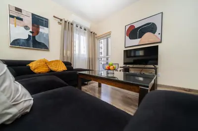a living room with a couch and a table at Seafront 1 bedroom flat in Limassol