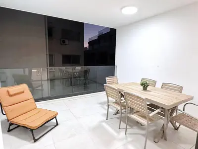 a dining room with a wooden table and chairs at Luna Mare in Limassol