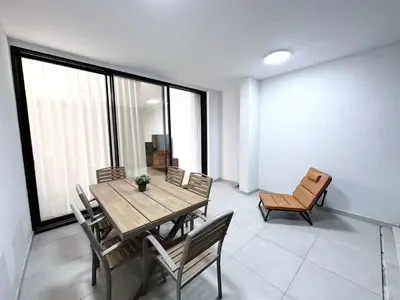a dining room with a wooden table and chairs at Luna Mare in Limassol