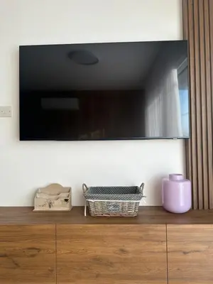 a television on top of a wooden dresser at CityLink-3Bedrooms Appartment CityCenter in Limassol