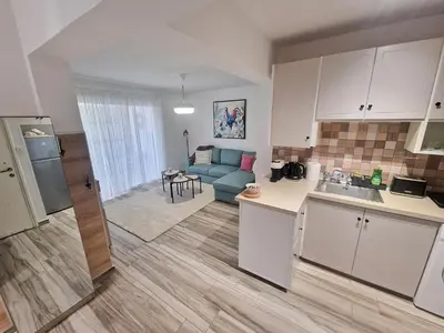 a kitchen and living room with a couch and a table at 1, bed Kapparis, Triumph 1 - A in Paralimni