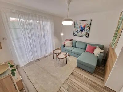 a living room with a blue couch and a table at 1, bed Kapparis, Triumph 1 - A in Paralimni