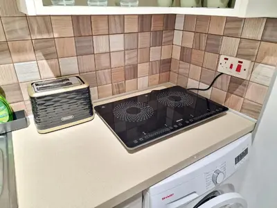 a kitchen with a stove top oven on a counter at 1, bed Kapparis, Triumph 1 - A in Paralimni