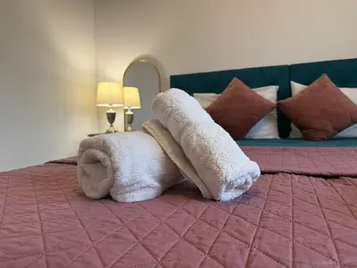 a stuffed elephant is sitting on a bed at Bella's Place - Stylish 2BD With large Veranda in Larnaka