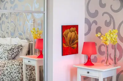 a bedroom with two tables with lamps and a bed at Omerou Apartment in Nicosia
