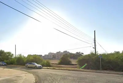 a car parked on the side of a road at Sunset Poolside Apartment with Pool facility in Larnaka