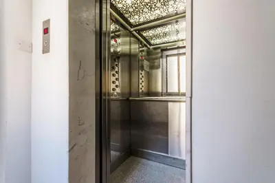 a glass door leading into a room with a window at Fam Glam Comfort Apartment in Larnaka
