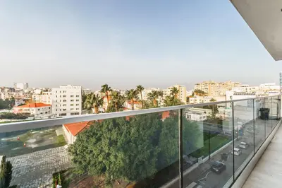 a balcony with a view of a city at Fam Glam Comfort Apartment in Larnaka
