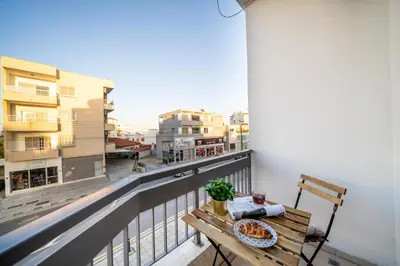 a table with a plate of food on a balcony at 1 bedroom flat near center in Nicosia
