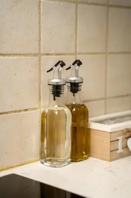 two glass bottles sitting on top of a counter at 1 bedroom flat near center in Nicosia