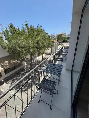 a row of benches on the balcony of a building at Loft 17 - fully renovated loft in centre in Limassol