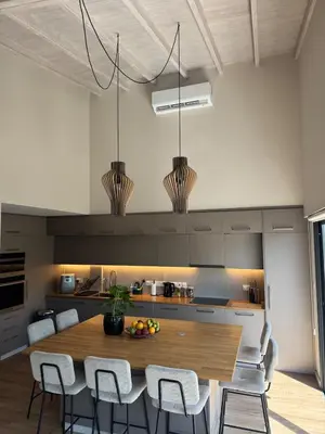 a kitchen with a wooden table and white chairs at Loft 17 - fully renovated loft in centre in Limassol