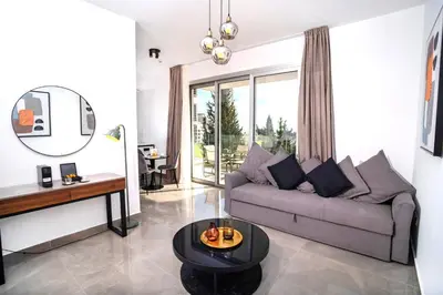 a living room with a couch and a table at Celeste Suites in Limassol