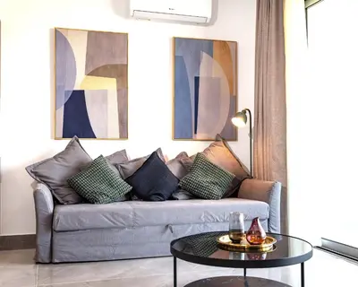 a living room with a couch and a table at Celeste Suites in Limassol