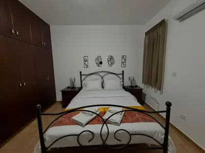 a bedroom with a bed with a metal frame at Villa Encanto - Private Heated Swimming Pool for winter months 5Bedroom in Voroklini