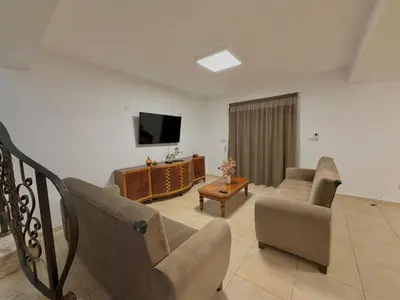 a living room with a couch and a tv at Villa Encanto - Private Heated Swimming Pool for winter months 5Bedroom in Voroklini